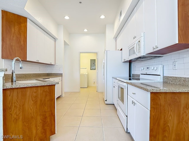 9260 Belleza Way Unit 203, Fort Myers, FL 33908 - kitchen with white appliances, tasteful backsplash, light tile patterned floors, white cabinets, and recessed lighting