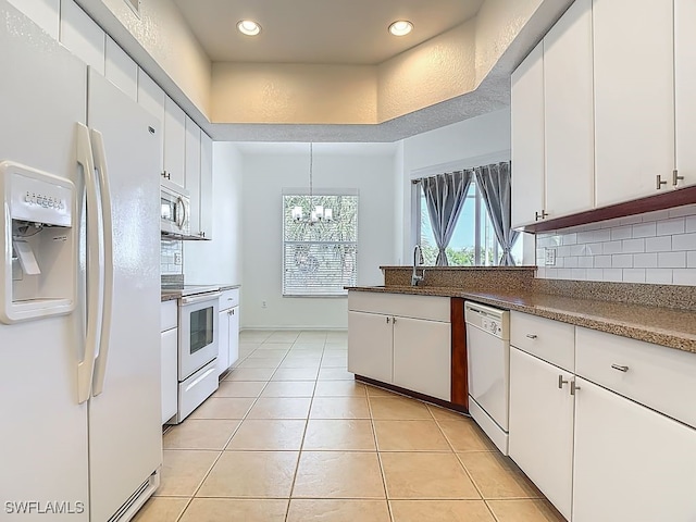 9260 Belleza Way Unit 203, Fort Myers, FL 33908 - kitchen with white appliances, white cabinetry, tasteful backsplash, a chandelier, and recessed lighting