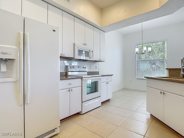 9260 Belleza Way Unit 203, Fort Myers, FL 33908 - kitchen with white appliances, decorative backsplash, and white cabinets