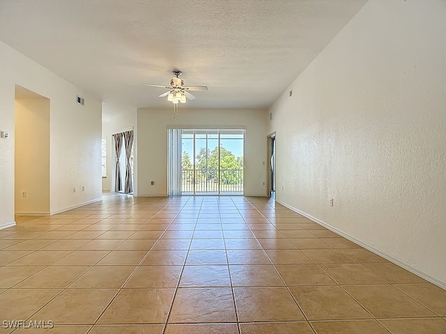 9260 Belleza Way Unit 203, Fort Myers, FL 33908 - empty room featuring a ceiling fan, light tile patterned floors, and a textured wall