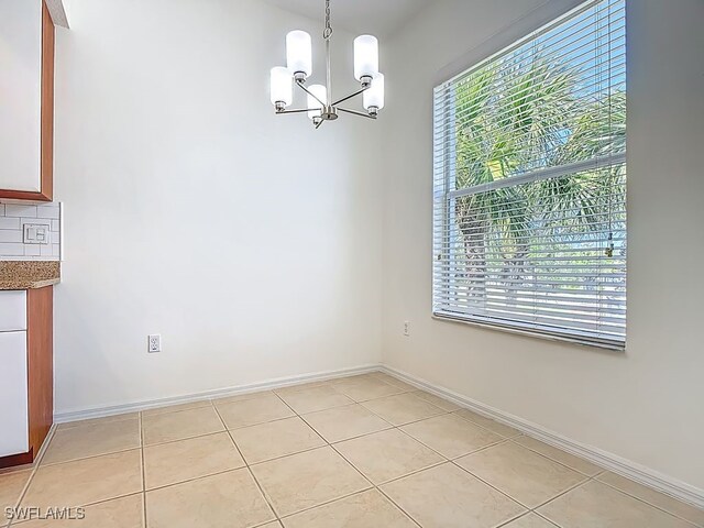9260 Belleza Way Unit 203, Fort Myers, FL 33908 - unfurnished dining area with a chandelier and light tile patterned floors
