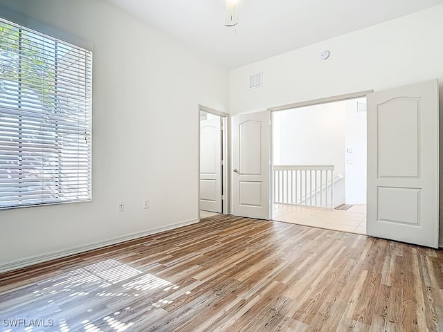9260 Belleza Way Unit 203, Fort Myers, FL 33908 - unfurnished bedroom featuring light wood finished floors and baseboards