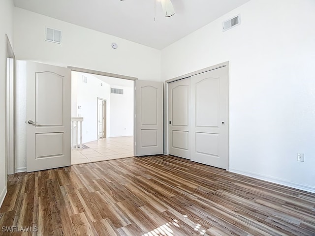 9260 Belleza Way Unit 203, Fort Myers, FL 33908 - unfurnished bedroom with wood finished floors, a closet, and a ceiling fan