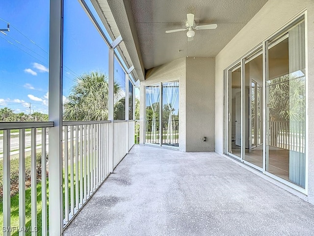 9260 Belleza Way Unit 203, Fort Myers, FL 33908 - unfurnished sunroom with ceiling fan, concrete floors, and a textured wall