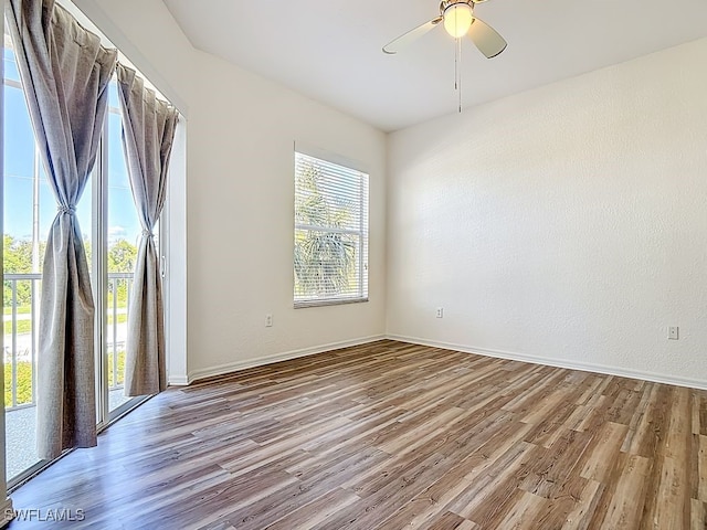 9260 Belleza Way Unit 203, Fort Myers, FL 33908 - unfurnished room featuring wood finished floors and a ceiling fan