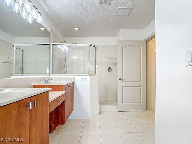 9260 Belleza Way Unit 203, Fort Myers, FL 33908 - bathroom featuring vanity, a stall shower, a textured ceiling, tile patterned floors, and recessed lighting