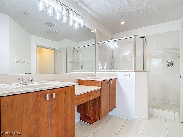 9260 Belleza Way Unit 203, Fort Myers, FL 33908 - bathroom featuring double vanity, tiled shower, a textured ceiling, tile patterned flooring, and recessed lighting