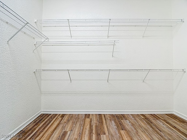 9260 Belleza Way Unit 203, Fort Myers, FL 33908 - walk in closet featuring wood finished floors