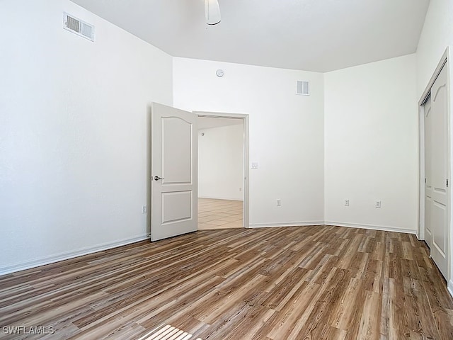 9260 Belleza Way Unit 203, Fort Myers, FL 33908 - unfurnished bedroom featuring wood finished floors and a closet