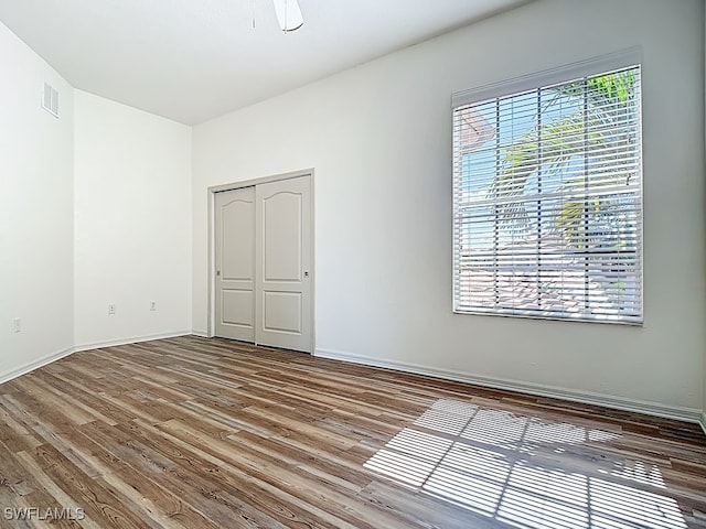 9260 Belleza Way Unit 203, Fort Myers, FL 33908 - unfurnished bedroom featuring wood finished floors and a closet