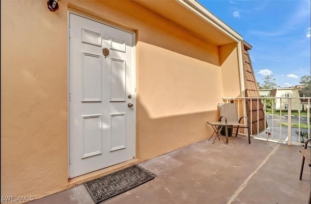 407 Meadowlark Ln Unit 407B, Naples, FL 34105 - doorway to property with stucco siding