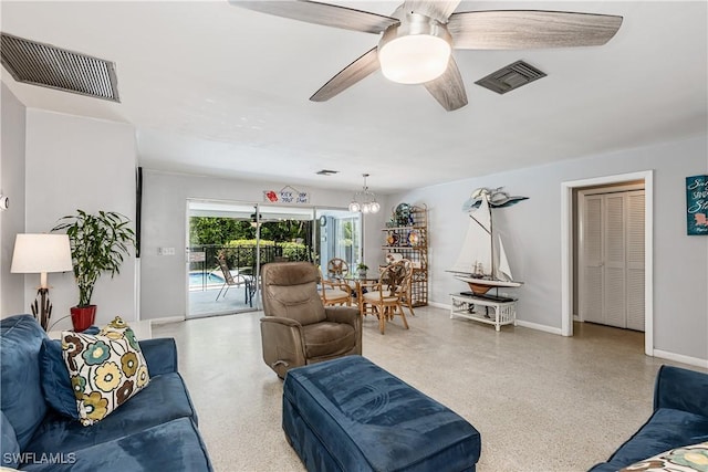 211 W Flamingo Cir, Marco Island, FL 34145 - living room with speckled floor, a ceiling fan, and a chandelier