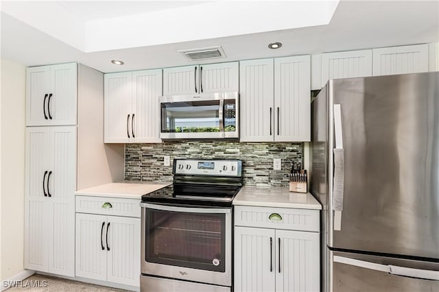 211 W Flamingo Cir, Marco Island, FL 34145 - kitchen featuring appliances with stainless steel finishes, light countertops, tasteful backsplash, recessed lighting, and white cabinetry
