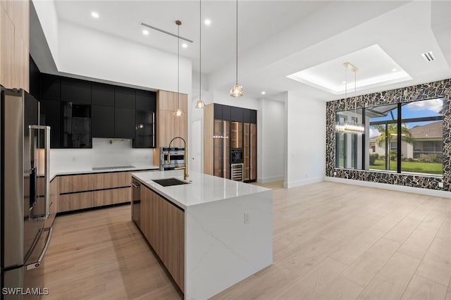 3620 SW 4th Ln, Cape Coral, FL 33991 - kitchen with stainless steel fridge with ice dispenser, modern cabinets, a tray ceiling, recessed lighting, and light wood-style floors