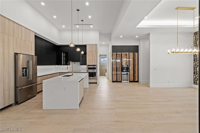 3620 SW 4th Ln, Cape Coral, FL 33991 - kitchen featuring stainless steel appliances, modern cabinets, light wood-style flooring, a large island with sink, and recessed lighting