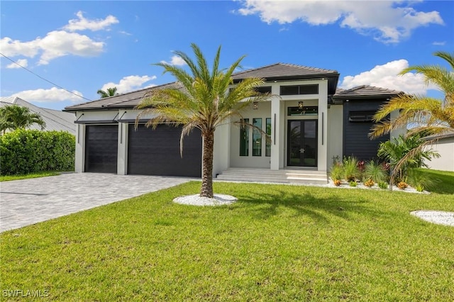 3620 SW 4th Ln, Cape Coral, FL 33991 - view of front facade with decorative driveway, a garage, a front yard, and stucco siding