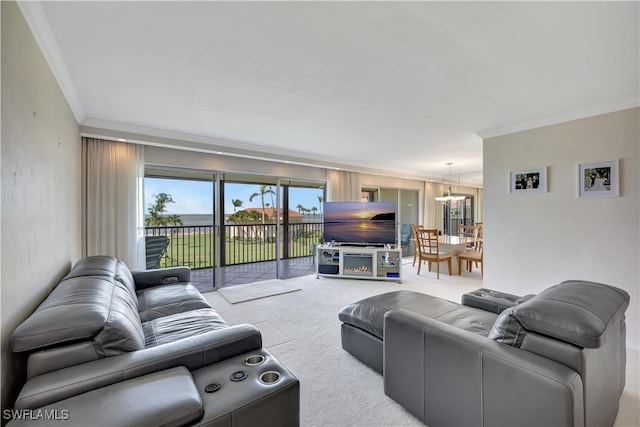 1080 S Collier Blvd Unit 305, Marco Island, FL 34145 - carpeted living room with ornamental molding and a chandelier