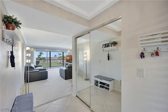 1080 S Collier Blvd Unit 305, Marco Island, FL 34145 - corridor featuring light tile patterned floors and light colored carpet