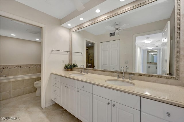1080 S Collier Blvd Unit 305, Marco Island, FL 34145 - bathroom with tile patterned flooring, double vanity, a bath, a ceiling fan, and recessed lighting