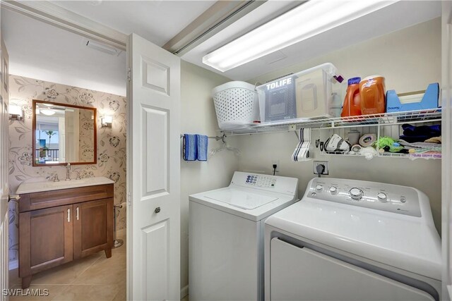 1080 S Collier Blvd Unit 305, Marco Island, FL 34145 - washroom with wallpapered walls, washer and clothes dryer, and light tile patterned flooring