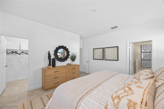 17752 Saddleback Loop, North Fort Myers, FL 33917 - bedroom with a walk in closet, light tile patterned flooring, and a closet