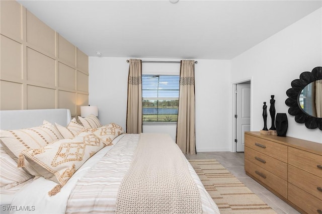 17752 Saddleback Loop, North Fort Myers, FL 33917 - bedroom with light tile patterned flooring and a decorative wall