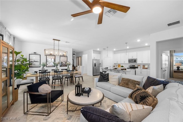17752 Saddleback Loop, North Fort Myers, FL 33917 - living room featuring a ceiling fan, recessed lighting, a chandelier, and light tile patterned flooring