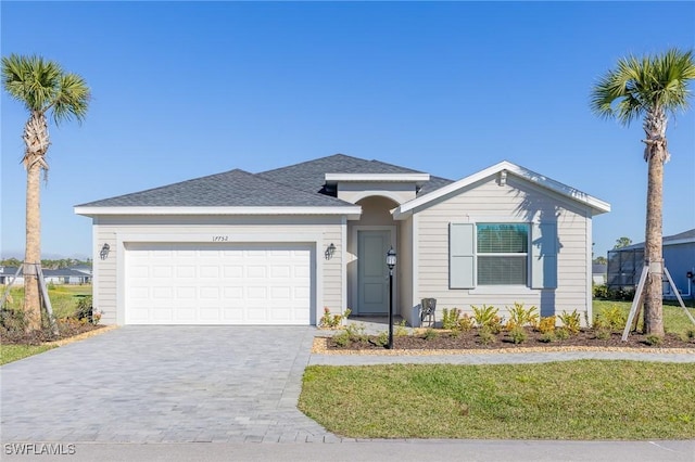 17752 Saddleback Loop, North Fort Myers, FL 33917 - ranch-style home featuring a garage, decorative driveway, a front lawn, and roof with shingles