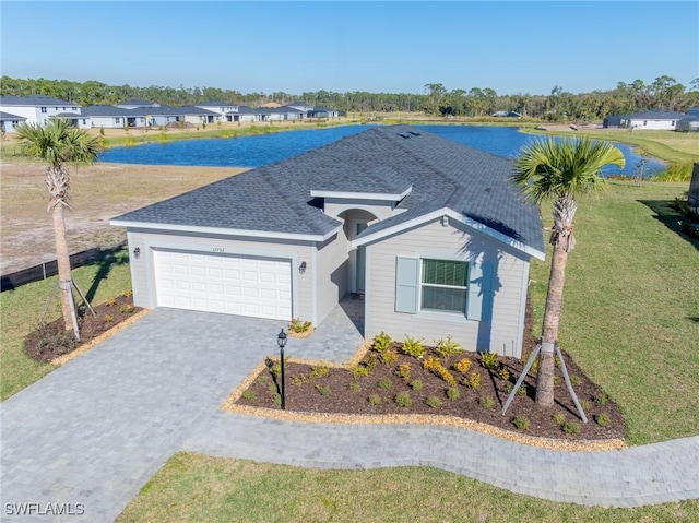 17752 Saddleback Loop, North Fort Myers, FL 33917 - view of front of property featuring a garage, decorative driveway, a front yard, and a water view