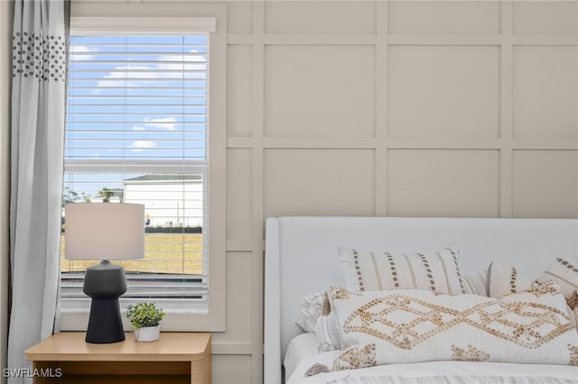 17752 Saddleback Loop, North Fort Myers, FL 33917 - bedroom featuring multiple windows and a decorative wall
