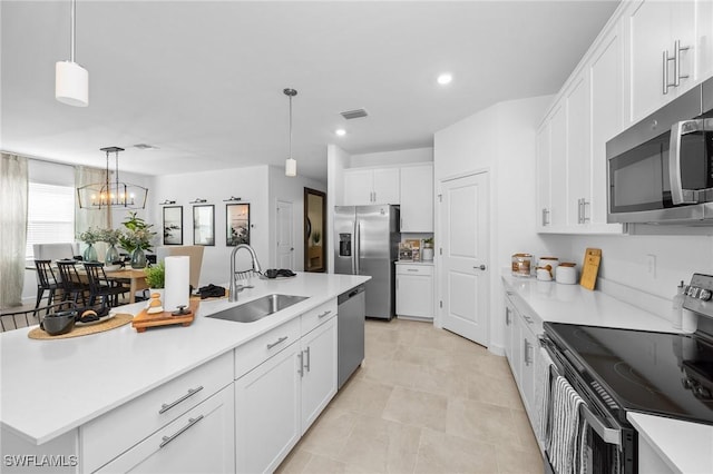 17752 Saddleback Loop, North Fort Myers, FL 33917 - kitchen with appliances with stainless steel finishes, white cabinets, light countertops, decorative light fixtures, and recessed lighting