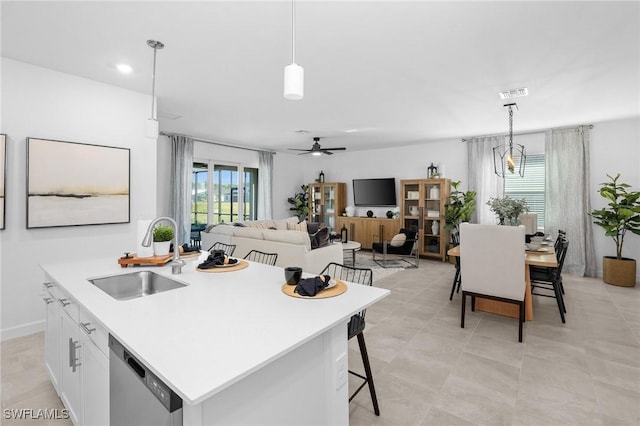 17752 Saddleback Loop, North Fort Myers, FL 33917 - kitchen with stainless steel dishwasher, decorative light fixtures, white cabinetry, an island with sink, and recessed lighting
