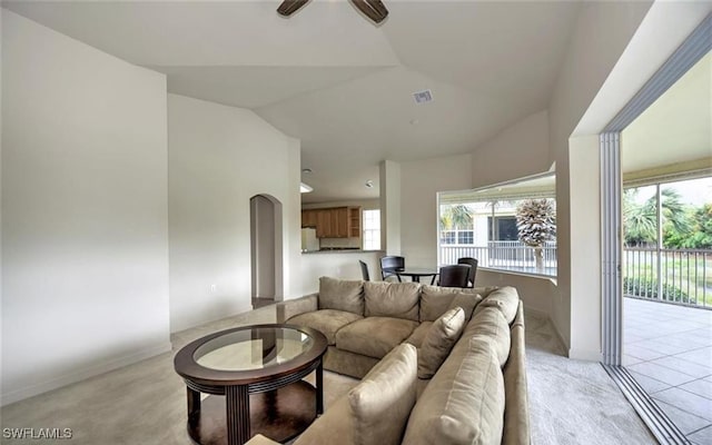 20250 Burnside Pl Unit 1502, Estero, FL 33928 - living room featuring a ceiling fan, light carpet, arched walkways, and lofted ceiling