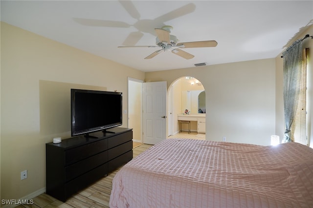 17139 Knight Dr, Fort Myers, FL 33967 - bedroom featuring arched walkways, light wood-style floors, ensuite bath, and ceiling fan