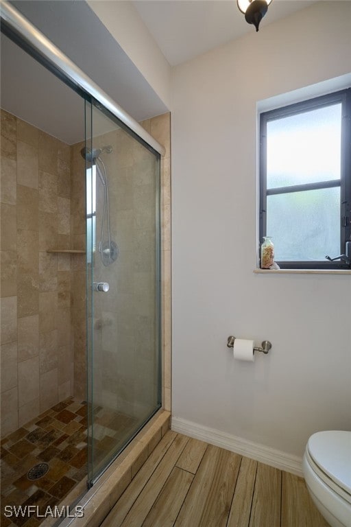 17139 Knight Dr, Fort Myers, FL 33967 - bathroom with plenty of natural light, a shower stall, and wood finished floors