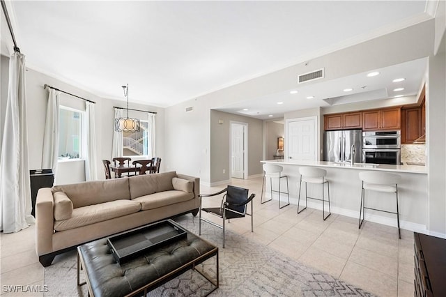 2738 Tiburon Blvd E Unit B406, Naples, FL 34109 - living room with light tile patterned floors, ornamental molding, and recessed lighting