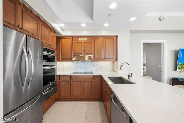 2738 Tiburon Blvd E Unit B406, Naples, FL 34109 - kitchen with stainless steel appliances, a warming drawer, brown cabinetry, backsplash, and recessed lighting