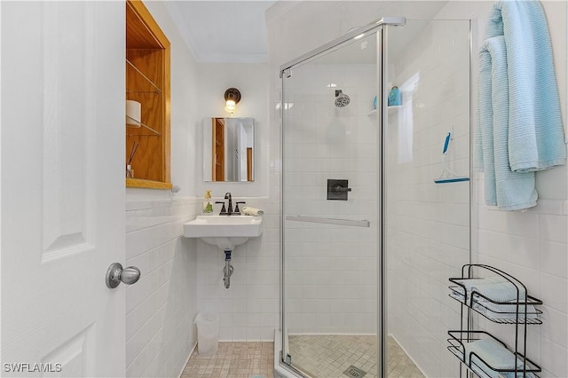 782 107th Ave N, Naples, FL 34108 - bathroom featuring tile walls, a shower stall, and ornamental molding