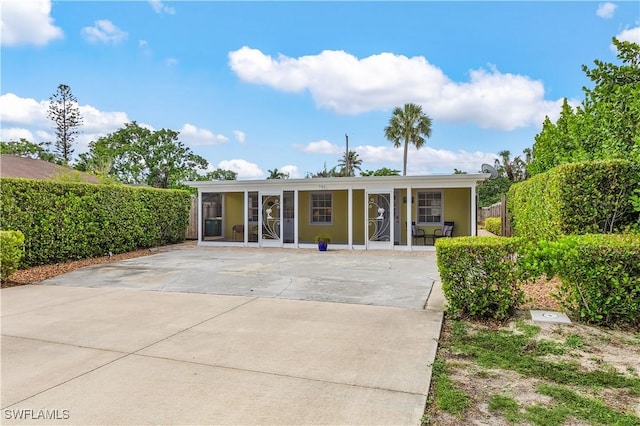 782 107th Ave N, Naples, FL 34108 - view of front facade featuring a porch and concrete driveway