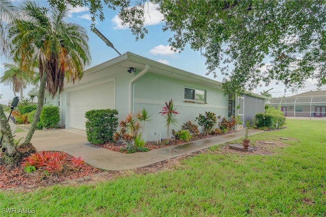 14539 Riverside Dr, Fort Myers, FL 33905 - view of home's exterior with a yard, a garage, stucco siding, and concrete driveway