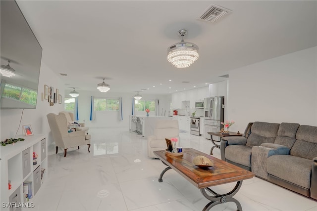 14539 Riverside Dr, Fort Myers, FL 33905 - living room with a chandelier and light marble finish flooring