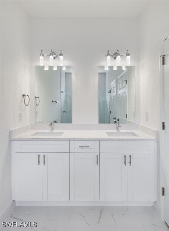 3000 25th St W, Lehigh Acres, FL 33971 - full bathroom featuring marble look tiles, double vanity, and a shower