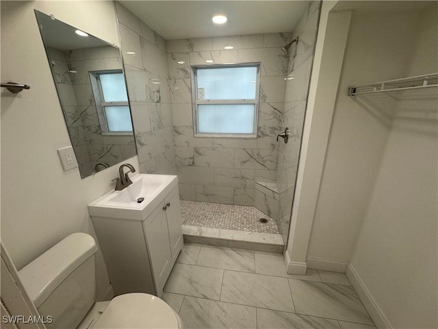 2590 1st St Unit 112, Fort Myers, FL 33901 - full bath featuring marble finish floors, healthy amount of natural light, a tile shower, and vanity
