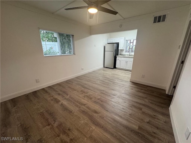 2590 1st St Unit 112, Fort Myers, FL 33901 - unfurnished living room featuring a ceiling fan, wood finished floors, and ornamental molding