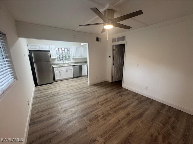 2590 1st St Unit 112, Fort Myers, FL 33901 - kitchen featuring appliances with stainless steel finishes, ceiling fan, wood finished floors, light countertops, and white cabinetry