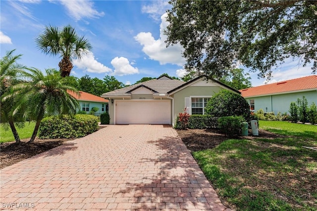 15139 Ligustrum Ln, Alva, FL 33920 - ranch-style house featuring decorative driveway, an attached garage, and stucco siding