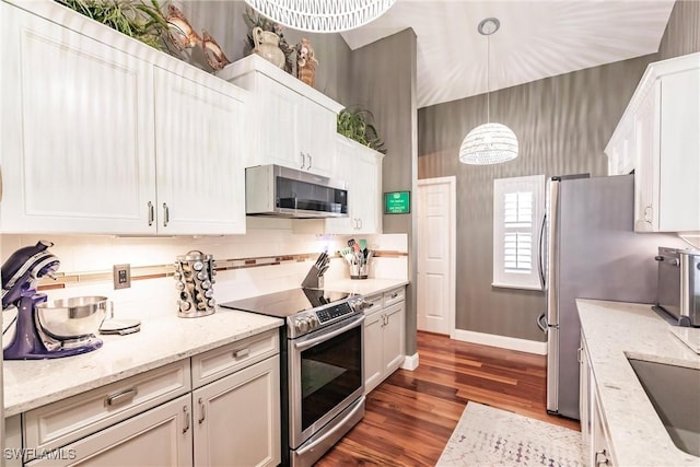 15139 Ligustrum Ln, Alva, FL 33920 - kitchen with appliances with stainless steel finishes, dark wood finished floors, white cabinets, hanging light fixtures, and light stone countertops