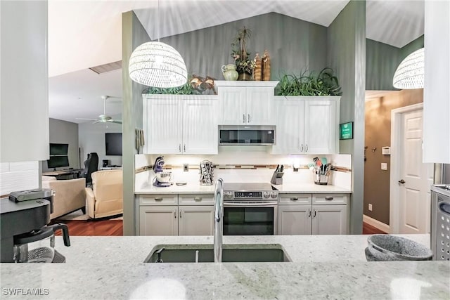 15139 Ligustrum Ln, Alva, FL 33920 - kitchen featuring appliances with stainless steel finishes, ceiling fan, light stone countertops, wood finished floors, and pendant lighting