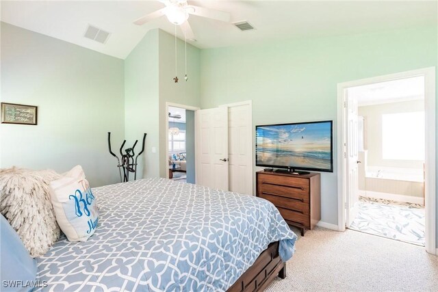 15139 Ligustrum Ln, Alva, FL 33920 - bedroom featuring light carpet, multiple windows, ensuite bathroom, ceiling fan, and high vaulted ceiling
