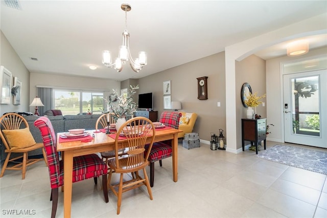 20095 Fiddlewood Ave, North Fort Myers, FL 33917 - dining area with a chandelier, arched walkways, and light tile patterned flooring